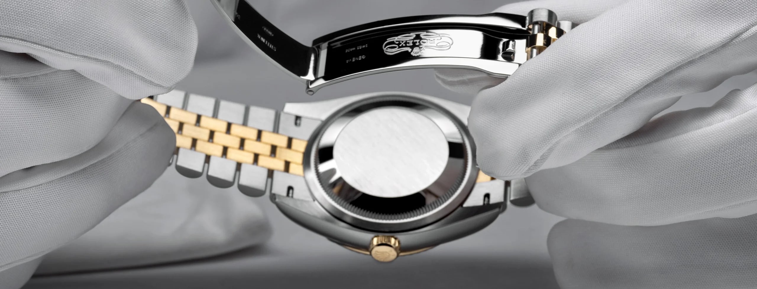 Watchmaker dismantling a Rolex movement