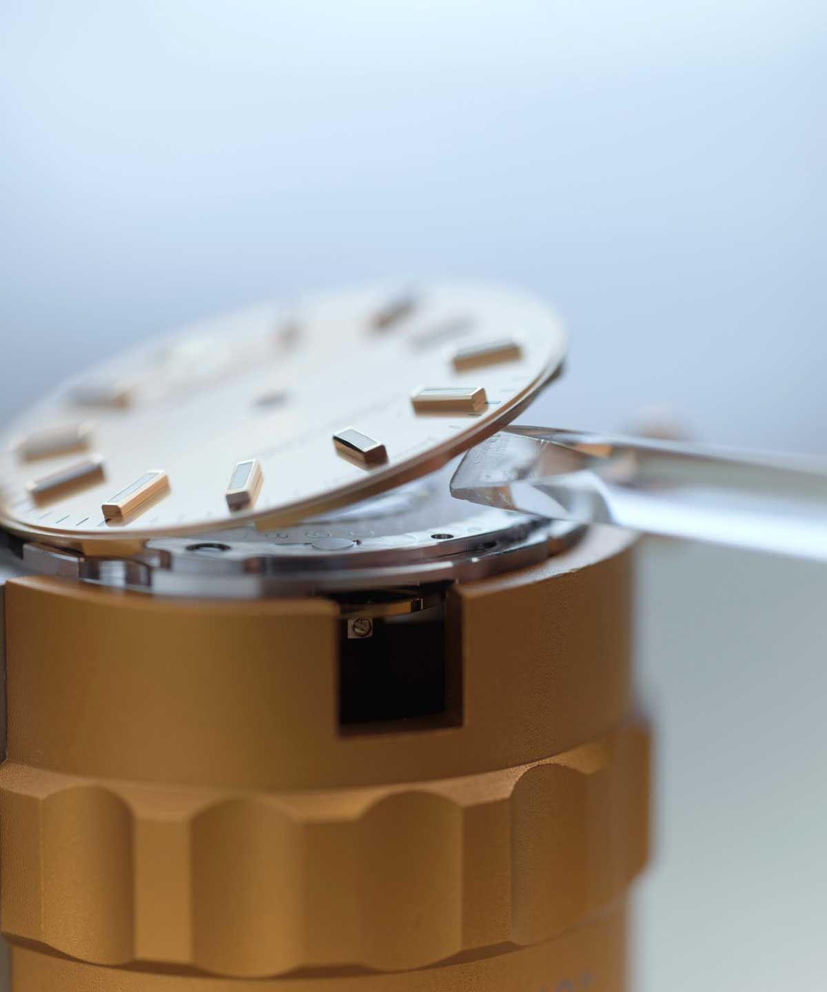 Close-up of a Rolex dial being removed during servicing
