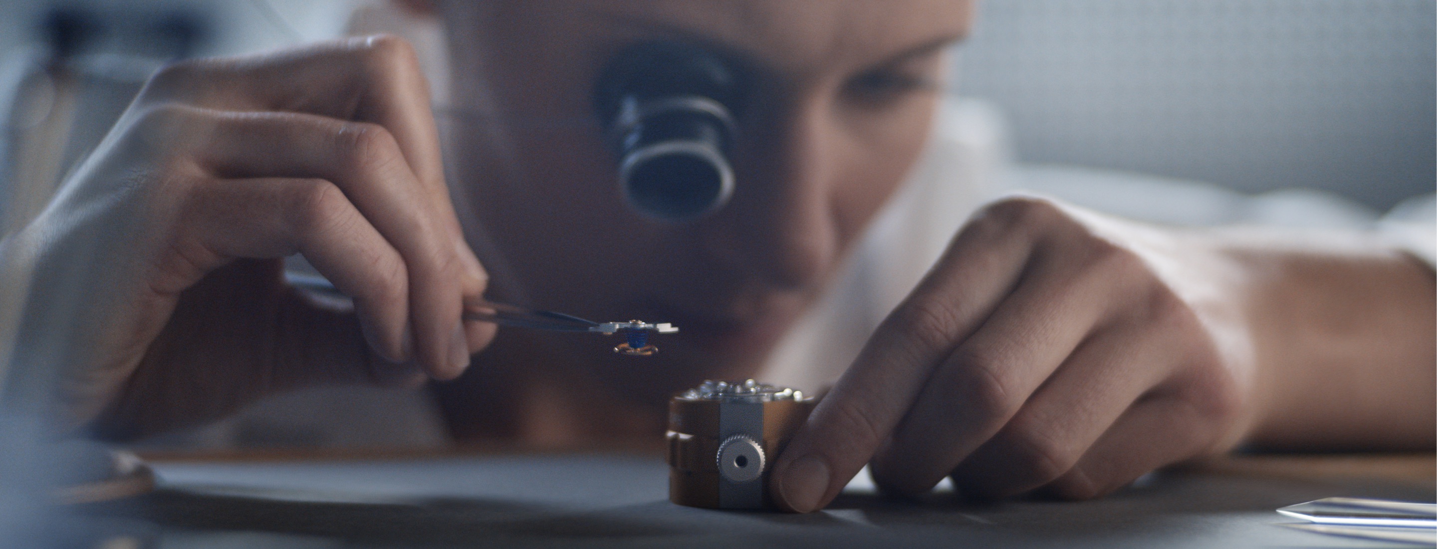 Watchmaker assembling a movement